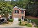 Charming two-story townhome with brick facade, attached garage, and beautifully landscaped front yard at 4221 Rogers Creek Ct, Duluth, GA 30096