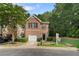 Charming brick two-story townhome with a single-car garage, manicured bushes, and a well-kept lawn at 4221 Rogers Creek Ct, Duluth, GA 30096