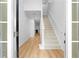Bright foyer showcases hardwood floors and a staircase leading to the upper level at 4221 Rogers Creek Ct, Duluth, GA 30096