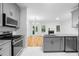 Modern kitchen featuring stainless steel appliances, granite countertops and ample cabinet space for storage at 4221 Rogers Creek Ct, Duluth, GA 30096