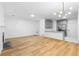 Open-concept living space featuring modern lighting, sleek floors, and a view into the kitchen at 4221 Rogers Creek Ct, Duluth, GA 30096