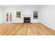 Open living area with fireplace, hardwood floors, and French doors for natural light at 4221 Rogers Creek Ct, Duluth, GA 30096