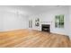 Bright living room featuring hardwood floors, a fireplace, and abundant natural light from the windows and french doors at 4221 Rogers Creek Ct, Duluth, GA 30096