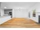 Bright and airy living room with hardwood floors, modern lighting, and a view of the kitchen at 4221 Rogers Creek Ct, Duluth, GA 30096