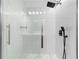 Walk in shower with glass door, rain style shower head, handheld shower, and marble tile at 4221 Rogers Creek Ct, Duluth, GA 30096