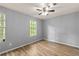 Clean, spacious bedroom with wood floors and a large window overlooking the outside at 4672 Satellite Blvd, Duluth, GA 30096