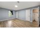 Bright bedroom features wood-look flooring, neutral walls, a large window, and multiple closets for ample storage at 4672 Satellite Blvd, Duluth, GA 30096