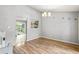 Spacious dining area with wood floors, chandelier, and doorway to kitchen at 4672 Satellite Blvd, Duluth, GA 30096