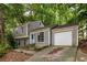 Charming gray two-story home with a blue front door, garage, and a driveway at 4672 Satellite Blvd, Duluth, GA 30096
