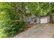 Exterior view of a charming two-story home with an attached garage and well-maintained landscaping at 4672 Satellite Blvd, Duluth, GA 30096