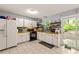 Well lit kitchen featuring white cabinets, butcher block countertops, and black appliances at 4672 Satellite Blvd, Duluth, GA 30096