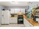 Charming kitchen with white cabinets, updated countertops, and stainless steel appliances at 4672 Satellite Blvd, Duluth, GA 30096