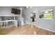 Open living area with wood floors, staircase, and view to kitchen at 4672 Satellite Blvd, Duluth, GA 30096