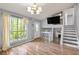 Open living area with wood floors, staircase, a TV on wall, and lots of light at 4672 Satellite Blvd, Duluth, GA 30096