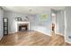 Bright living room features a brick fireplace, wood floors, and natural light at 4672 Satellite Blvd, Duluth, GA 30096