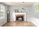 Bright living room features a brick fireplace, wood floors, and natural light at 4672 Satellite Blvd, Duluth, GA 30096