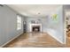 Bright living room features a brick fireplace, wood floors, and natural light at 4672 Satellite Blvd, Duluth, GA 30096