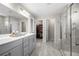 Modern bathroom featuring a glass-enclosed shower and a large vanity with double sinks at 916 Gambino Trce, Peachtree City, GA 30269