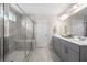 Modern bathroom with a glass-enclosed shower, a large vanity with double sinks, and tiled floors at 916 Gambino Trce, Peachtree City, GA 30269