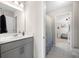 Bathroom featuring modern vanity, a toilet, and view of the bedroom at 916 Gambino Trce, Peachtree City, GA 30269