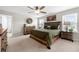 Spacious bedroom features a wooden bed, large windows, ceiling fan and a dresser set at 916 Gambino Trce, Peachtree City, GA 30269