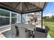 Inviting covered patio with stone fireplace and ample seating for outdoor entertaining at 916 Gambino Trce, Peachtree City, GA 30269