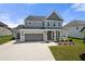Charming home featuring gray siding, white trim, and a spacious driveway leading to a convenient attached garage at 916 Gambino Trce, Peachtree City, GA 30269