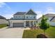 Beautiful two-story home featuring a well-manicured lawn, gray siding, and an attached two-car garage at 916 Gambino Trce, Peachtree City, GA 30269