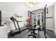 Well-equipped home gym with treadmill, weight rack, and rubber flooring for fitness enthusiasts at 916 Gambino Trce, Peachtree City, GA 30269