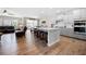 Open-concept kitchen featuring a large center island, modern appliances, and seamless flow to living areas at 916 Gambino Trce, Peachtree City, GA 30269