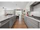 Bright kitchen features gray cabinets, stainless steel appliances, and an island with stone countertops at 916 Gambino Trce, Peachtree City, GA 30269