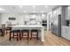 Spacious kitchen with an expansive island, seating, stainless appliances and stylish grey cabinetry at 916 Gambino Trce, Peachtree City, GA 30269