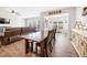 Open concept living with wood floors, dining table, and plush sofa with abundant natural light at 916 Gambino Trce, Peachtree City, GA 30269