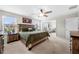 Spacious main bedroom features a wooden bed, large windows, ceiling fan and a dresser set at 916 Gambino Trce, Peachtree City, GA 30269