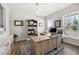 Bright home office featuring a large wooden desk, stylish decor, and an inviting atmosphere for productivity at 916 Gambino Trce, Peachtree City, GA 30269