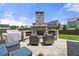 Relaxing outdoor stone fireplace with comfortable seating on a stone patio at 916 Gambino Trce, Peachtree City, GA 30269