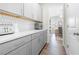 Pantry featuring ample storage with grey cabinets and a seamless transition to the adjacent home office at 916 Gambino Trce, Peachtree City, GA 30269