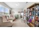 Cozy sitting area with chairs and a bookshelf is brightly lit by natural light from windows at 916 Gambino Trce, Peachtree City, GA 30269