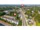 Aerial view of townhomes near a highway and surrounded by a canopy of trees and greenery at 100 Villa Magnolia Ln, Alpharetta, GA 30009