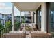Inviting covered balcony features plush seating and a view of the surrounding neighborhood at 100 Villa Magnolia Ln, Alpharetta, GA 30009