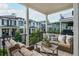 Relaxing balcony with comfortable seating overlooking townhomes and lush landscaping at 100 Villa Magnolia Ln, Alpharetta, GA 30009
