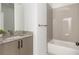 Well-lit bathroom featuring granite countertop, and tiled shower and tub at 100 Villa Magnolia Ln, Alpharetta, GA 30009