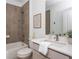 Well-lit bathroom with tiled shower, soaking tub, and modern fixtures and white countertop at 100 Villa Magnolia Ln, Alpharetta, GA 30009