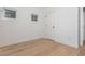 Clean, empty bedroom with wood floors, neutral paint, and multiple windows at 100 Villa Magnolia Ln, Alpharetta, GA 30009