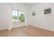 Bright, empty bedroom with three windows, hardwood floors, and neutral paint at 100 Villa Magnolia Ln, Alpharetta, GA 30009