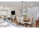 Open concept dining space with hardwood floors, brick wall, and modern lighting fixture at 100 Villa Magnolia Ln, Alpharetta, GA 30009