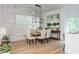 Bright dining room with large windows, stylish chandelier, and hardwood floors at 100 Villa Magnolia Ln, Alpharetta, GA 30009