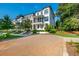 Paver driveway and street view of modern townhomes in a manicured community at 100 Villa Magnolia Ln, Alpharetta, GA 30009