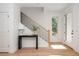 Bright, inviting entryway with hardwood floors and staircase with iron railings at 100 Villa Magnolia Ln, Alpharetta, GA 30009
