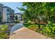 Scenic walking path showcasing the exteriors of townhomes with balconies and lush landscaping at 100 Villa Magnolia Ln, Alpharetta, GA 30009